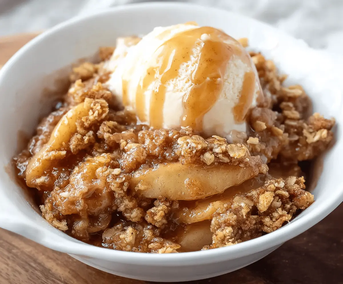 Delicious homemade apple crisp topped with golden brown streusel, served in a rustic bowl, perfect for fall desserts