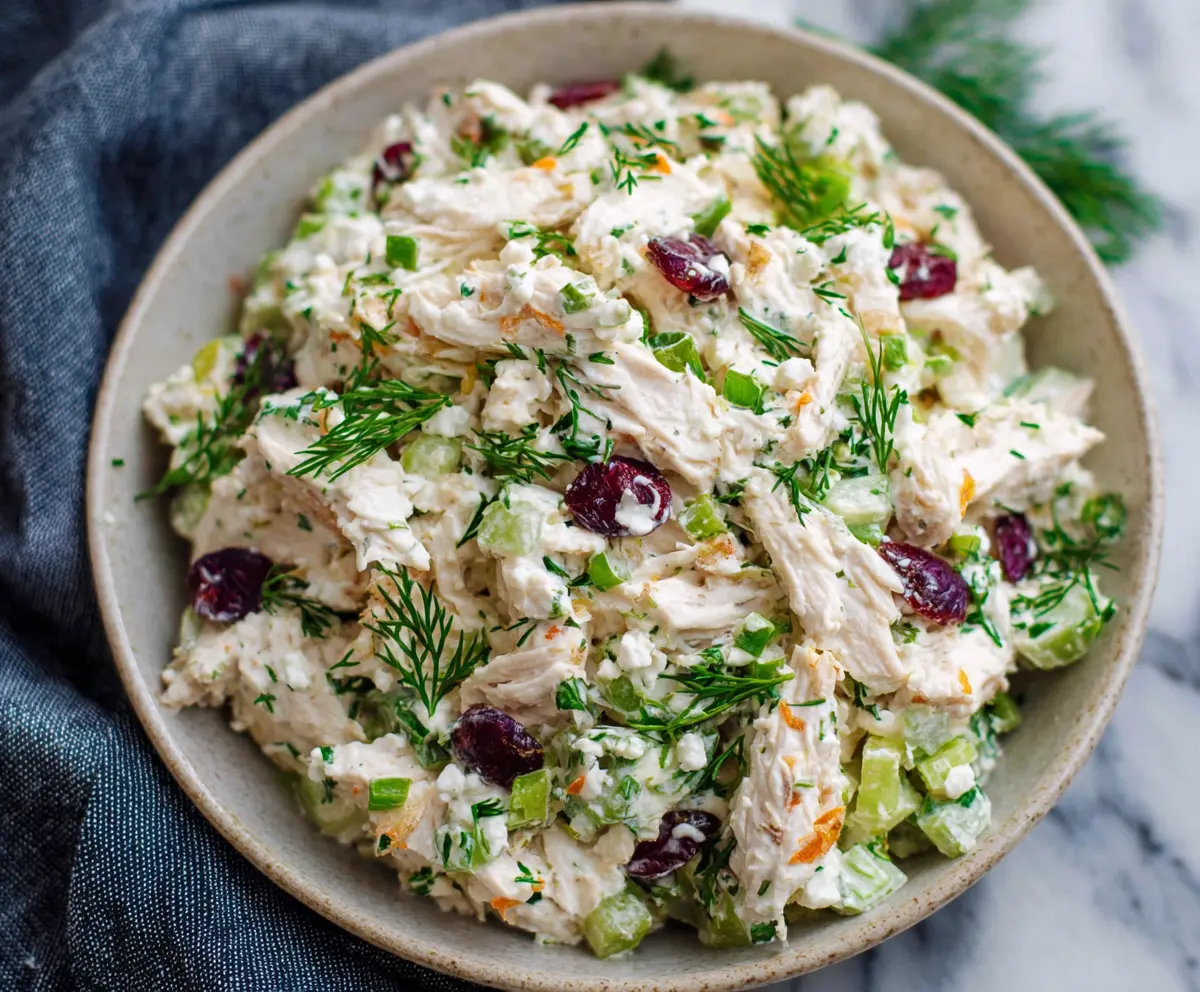 Creamy cottage cheese chicken salad with fresh herbs and vegetables in a white bowl.