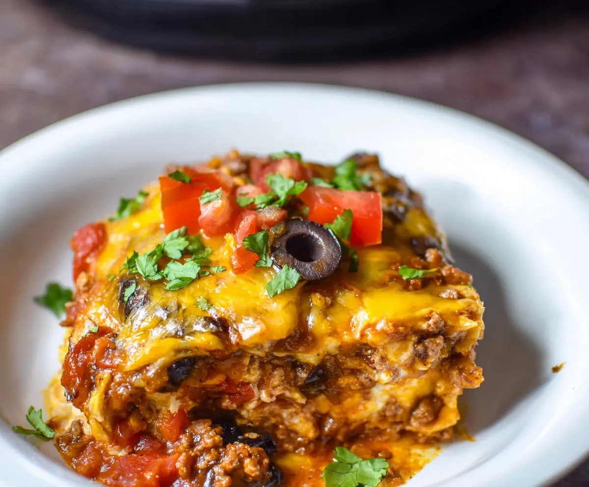 Delicious Crockpot Beef Enchilada Casserole with melted cheese and flavorful beef in a slow cooker.