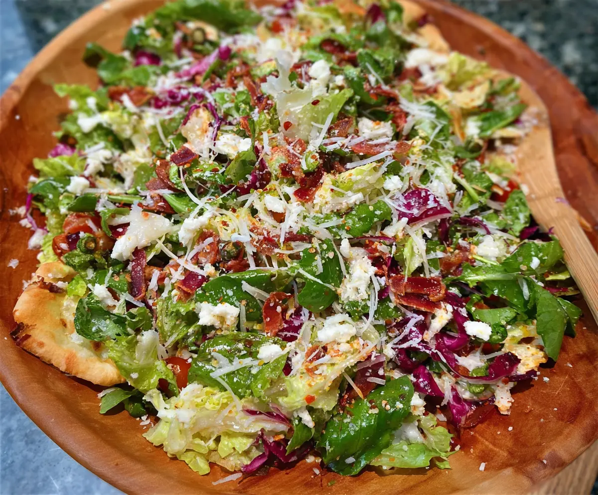Fresh Pizza Night Salad with mixed greens, cherry tomatoes, and melted cheese, perfect for a quick dinner.
