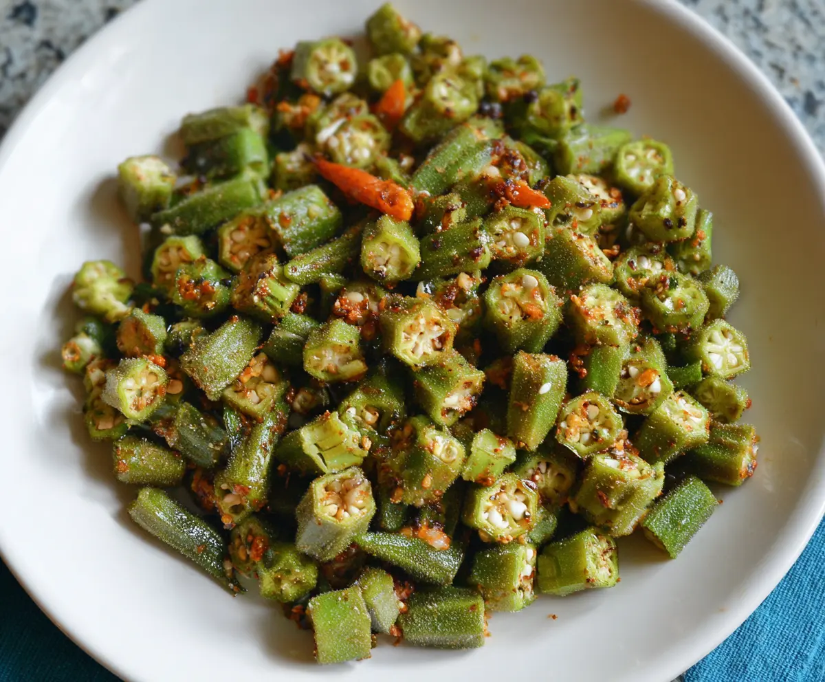 Crispy Fried Okra Guyanese Style served on a plate garnished with herbs.
