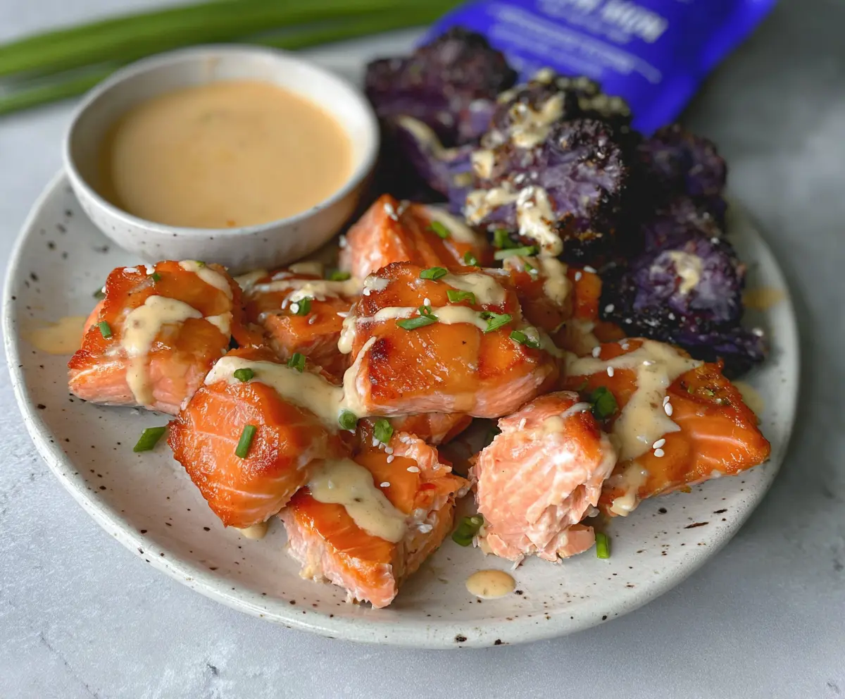 Delicious Miso Air Fryer Salmon Bites served on a plate with garnishes.
